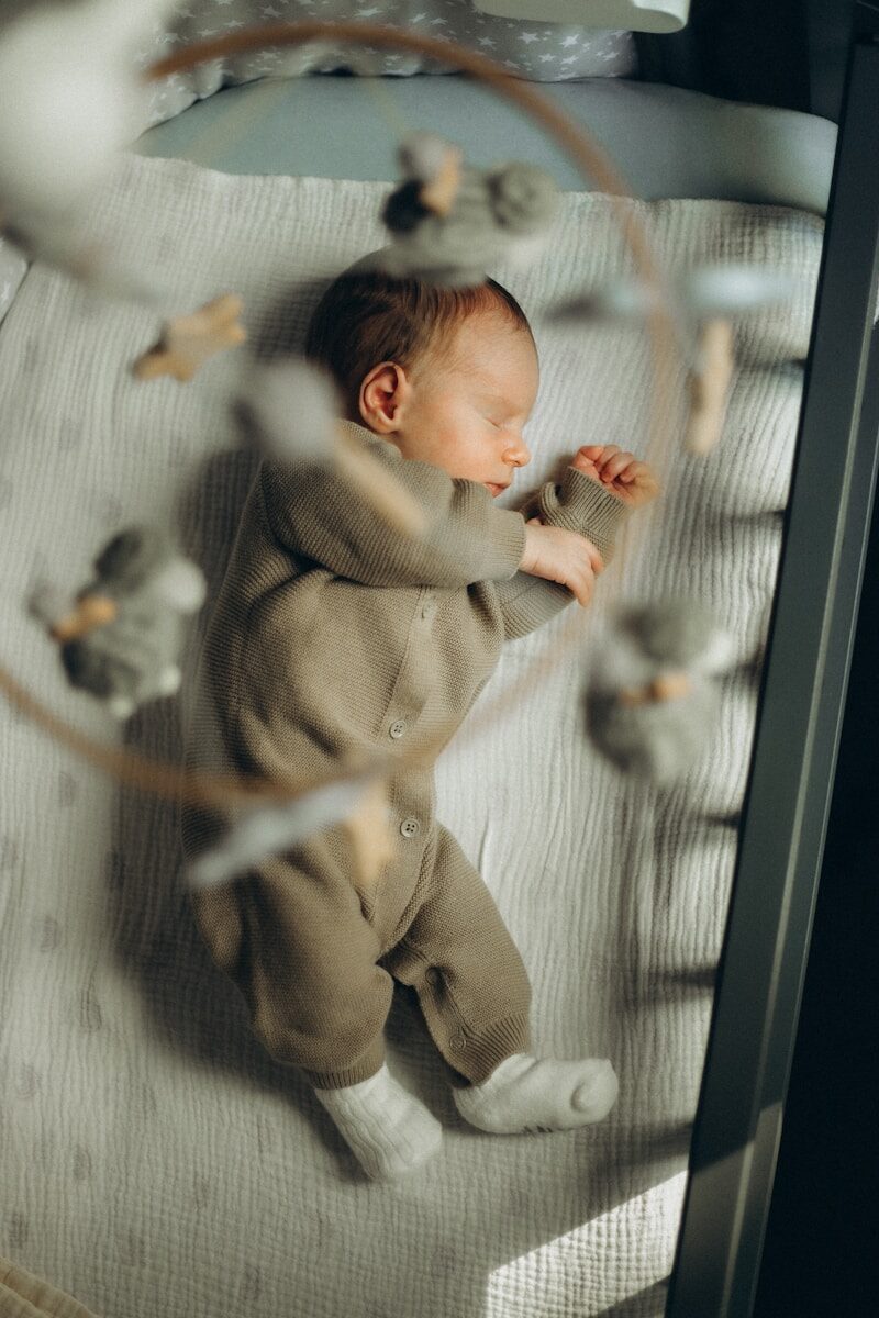Newborn baby sleeping peacefully in a crib.